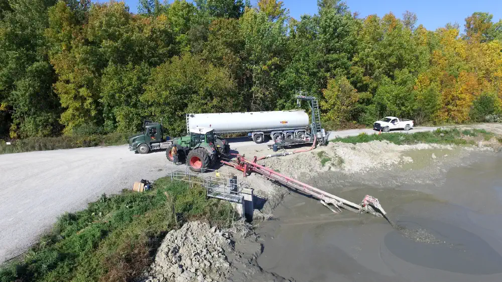 Truck being loaded at a lagoonm with a lagoon pump