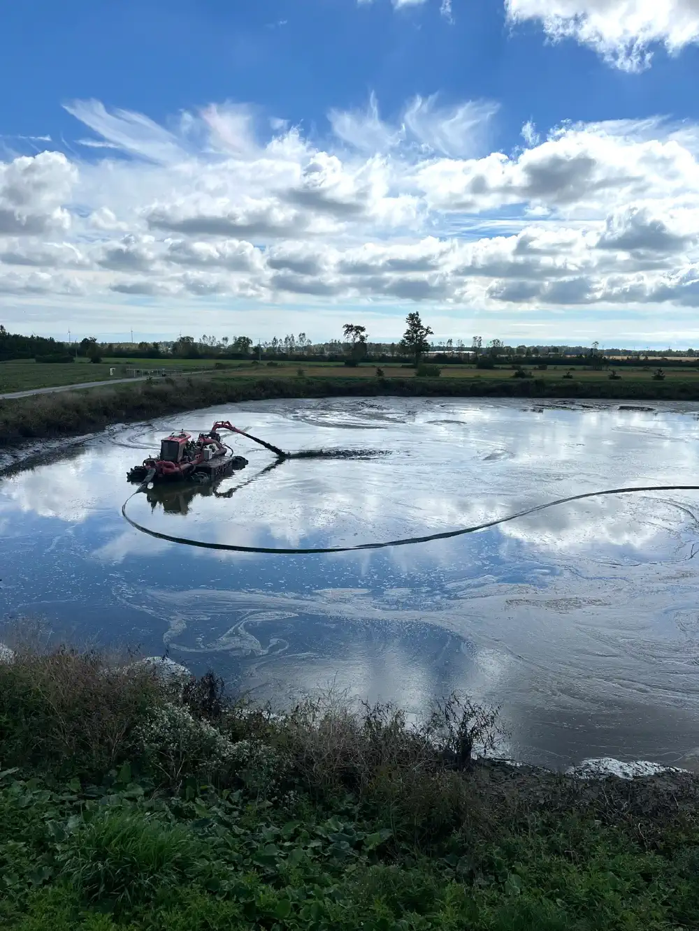 Lagoon crawler mixing material in the lagoon