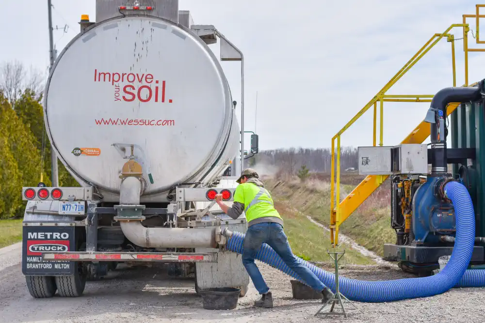 Truck being unloaded at a field