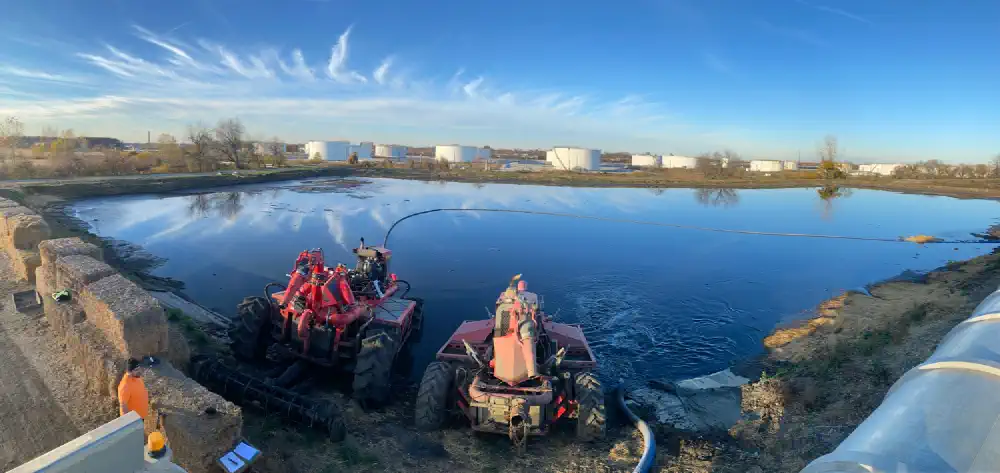 Lagoon with two crawlers used for material removal